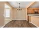 Open dining room with modern chandelier, hardwood floors and open to kitchen at 13998 Avalon Blvd, Fishers, IN 46037