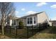 Home exterior features a black metal fence, lush lawn, and many windows to allow for ample sunlight at 13998 Avalon Blvd, Fishers, IN 46037