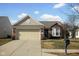 Charming single-story brick home with a two-car garage and well-maintained lawn at 13998 Avalon Blvd, Fishers, IN 46037