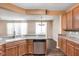 Open kitchen features a large island with stainless steel dishwasher and sink at 13998 Avalon Blvd, Fishers, IN 46037