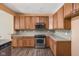 Well-lit kitchen boasts wood cabinets, stainless steel appliances, and a tiled backsplash at 13998 Avalon Blvd, Fishers, IN 46037