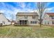 Backyard view of home featuring a screened in porch and well-maintained lawn at 1563 Old Thicket Ct, Greenwood, IN 46143
