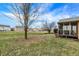 Green backyard featuring a screened in porch and bare trees, with neighborhood in background at 1563 Old Thicket Ct, Greenwood, IN 46143