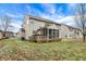 Backyard view of home with screened porch and spacious green lawn at 1563 Old Thicket Ct, Greenwood, IN 46143