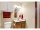 Bathroom features a toilet, wooden vanity, and a white medicine cabinet with a towel rack at 1563 Old Thicket Ct, Greenwood, IN 46143