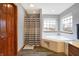 Bright bathroom features a soaking tub with white tile surround, modern vanity, and wood-look flooring at 1563 Old Thicket Ct, Greenwood, IN 46143