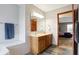 Bright bathroom features a double sink vanity, soaking tub, wood-look flooring, and access to the main bedroom at 1563 Old Thicket Ct, Greenwood, IN 46143