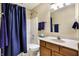 This bathroom features a coordinated shower curtain and towel set, paired with a wooden vanity at 1563 Old Thicket Ct, Greenwood, IN 46143