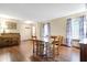 Formal dining room features hardwood floors, piano, and a wooden table with four chairs at 1563 Old Thicket Ct, Greenwood, IN 46143