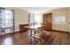 A dining room with hardwood floors, wooden table and chairs, and large wooden china cabinet at 1563 Old Thicket Ct, Greenwood, IN 46143