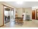 Bright kitchen with an eat-in table, white mini-fridge, and slider to covered porch at 1563 Old Thicket Ct, Greenwood, IN 46143