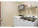This laundry room features a new washer and dryer set, complemented by a convenient storage shelf at 1563 Old Thicket Ct, Greenwood, IN 46143