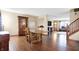 Open-concept living space with a dining area, hardwood floors, and staircase to the second floor at 1563 Old Thicket Ct, Greenwood, IN 46143