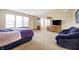 Spacious main bedroom with large windows, carpet flooring, and comfy seating offers a cozy space at 1563 Old Thicket Ct, Greenwood, IN 46143
