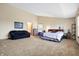 Spacious main bedroom with seating, carpet flooring, and neutral walls offers a cozy retreat at 1563 Old Thicket Ct, Greenwood, IN 46143