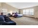 Bright main bedroom with large windows, comfy seating, and neutral carpet offers a relaxing space at 1563 Old Thicket Ct, Greenwood, IN 46143