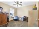 Office featuring carpet, a ceiling fan, a large window, a blue beanbag chair, and filing cabinets at 1563 Old Thicket Ct, Greenwood, IN 46143