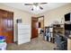 Office featuring carpet, a ceiling fan, a built-in desk, shelving, and filing cabinets at 1563 Old Thicket Ct, Greenwood, IN 46143
