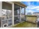 View of a screened porch with outdoor seating; grill on deck overlooking fenced-in yard at 1563 Old Thicket Ct, Greenwood, IN 46143