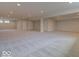 A large carpeted basement with recessed lighting provides ample room for recreation and/or storage at 15915 Bellows Dr, Fishers, IN 46040