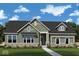 Two-story craftsman style home with gray siding, stone accents, and landscaping at 15915 Bellows Dr, Fishers, IN 46040