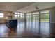 Spacious living room with hardwood floors and large windows offering abundant natural light and scenic outdoor views at 15915 Bellows Dr, Fishers, IN 46040