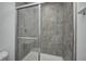 Shower with glass door, tiled walls, and chrome fixtures at 1934 Black Oak Dr, Shelbyville, IN 46176