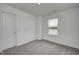 Cozy bedroom with carpeted floor, featuring a side window with backyard view at 1934 Black Oak Dr, Shelbyville, IN 46176