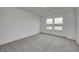 Bright bedroom features plush carpeting, neutral walls, and a double window offering scenic outdoor views at 1934 Black Oak Dr, Shelbyville, IN 46176