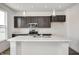 Kitchen features an island with stainless steel appliances and modern light fixtures at 1934 Black Oak Dr, Shelbyville, IN 46176