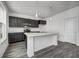 Modern kitchen features an island with white marble countertop and stainless steel appliances at 1934 Black Oak Dr, Shelbyville, IN 46176