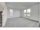 Bright living room with neutral carpet, stairs, and large windows at 1934 Black Oak Dr, Shelbyville, IN 46176