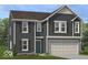 Charming two-story home features blue siding, shutters, a two car garage and a well manicured lawn at 1935 Black Oak Dr, Shelbyville, IN 46176