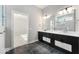 Modern bathroom featuring dual sinks, black cabinets, and a luxurious tiled shower at 19997 Old Dock Rd, Westfield, IN 46074