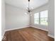 Bright dining room featuring hardwood floors, large windows, and a modern chandelier at 19997 Old Dock Rd, Westfield, IN 46074