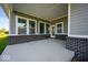 Covered back patio with brick accents, concrete floors, and large windows providing plenty of natural light at 19997 Old Dock Rd, Westfield, IN 46074