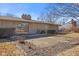 Backyard view of stone facade, sliding glass door and concrete patio at 2016 Colt Rd, Indianapolis, IN 46227