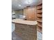 Basement bar area featuring stone accents, wood paneling, and built-in shelving and bar top at 2016 Colt Rd, Indianapolis, IN 46227