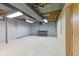Unfinished basement featuring bare ceiling, concrete walls, and concrete floors with workbench at 2016 Colt Rd, Indianapolis, IN 46227