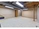 Unfinished basement featuring bare ceiling, concrete walls, and concrete floors with workbench at 2016 Colt Rd, Indianapolis, IN 46227
