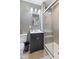 Bathroom featuring vanity with dark wood cabinets, tiled walk-in shower, and neutral paint at 2016 Colt Rd, Indianapolis, IN 46227