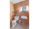 Small bathroom with wood-paneled walls, tiled floor, and updated sink, toilet and fixtures at 2016 Colt Rd, Indianapolis, IN 46227