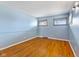 Spacious bedroom features hardwood floors, two windows providing great natural light and neutral paint at 2016 Colt Rd, Indianapolis, IN 46227
