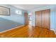 Comfortable bedroom with hardwood flooring, natural light, and convenient access to the closet and the rest of the home at 2016 Colt Rd, Indianapolis, IN 46227