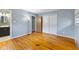 Large bedroom with hardwood flooring, natural light, closet, and conveniently located next to the bathroom at 2016 Colt Rd, Indianapolis, IN 46227
