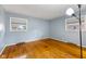 This spacious bedroom features hardwood floors and a pair of bright windows at 2016 Colt Rd, Indianapolis, IN 46227