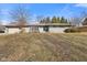 Charming single-story home featuring a stone facade, attached garage, and well-maintained front yard at 2016 Colt Rd, Indianapolis, IN 46227