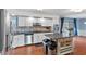 Bright kitchen with white cabinetry, stainless steel appliances, and a stylish island for food preparation at 2016 Colt Rd, Indianapolis, IN 46227