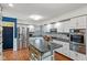 Modern kitchen with white cabinets, a stone backsplash, stainless steel appliances, and a central island at 2016 Colt Rd, Indianapolis, IN 46227