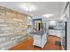 Well-lit kitchen with white cabinets, stainless steel appliances, and an island creating a functional space at 2016 Colt Rd, Indianapolis, IN 46227